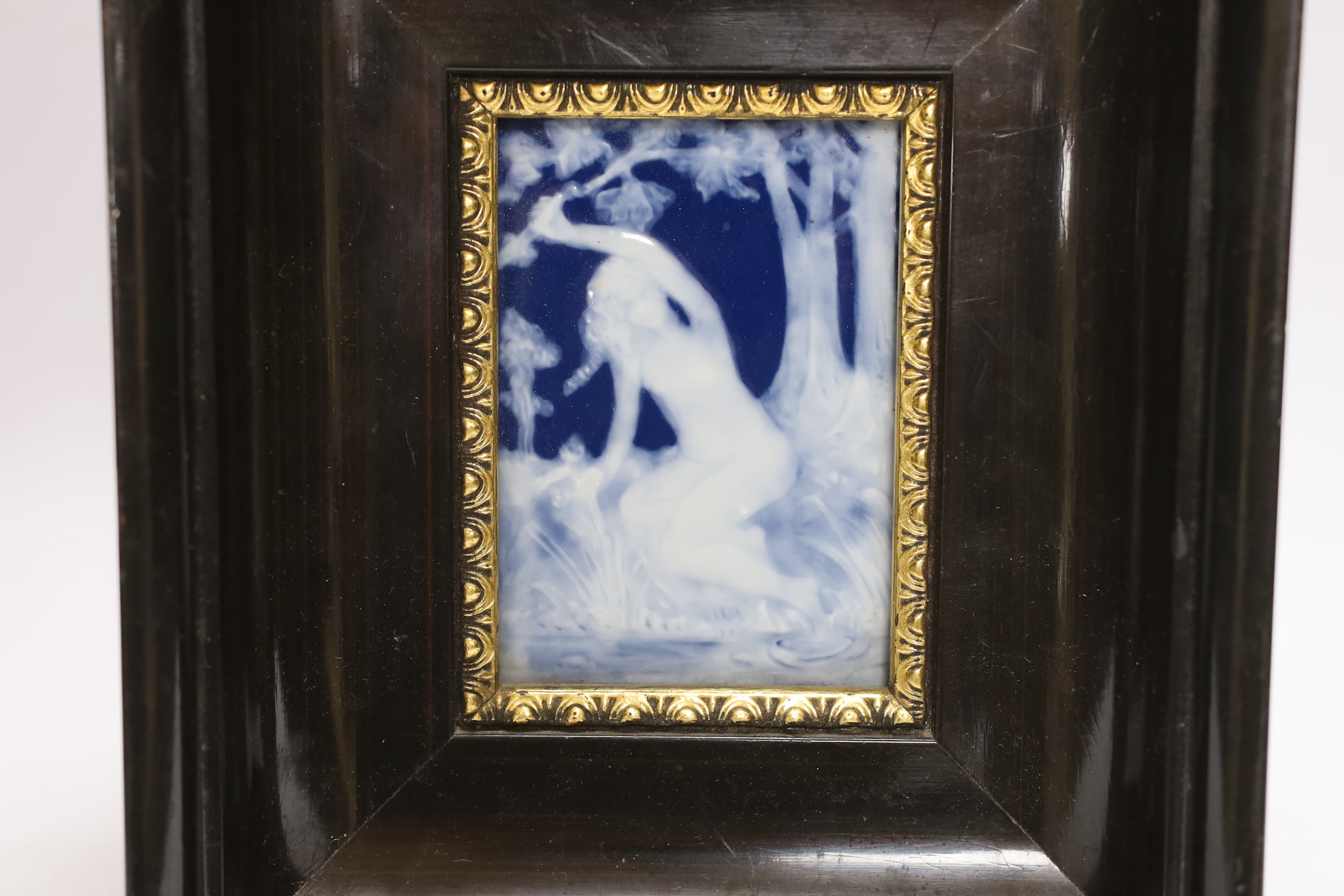 A Limoges pate sur pate plaque of a maiden in a wooded landscape by Marcel Chaufriasse, framed, overall 21 x 18cm
